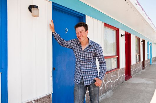 Young man looking for his ugly motel room