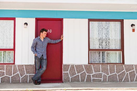 Young man looking for his hotel room