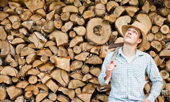 Woodcutter with straw hat on a background of wood