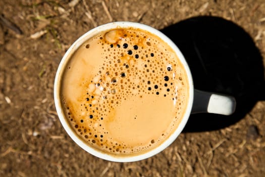 Close-up cup of fresh coffee on the ground