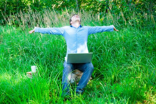 Young man enjoying the wireless technology in the middle of nowhere !