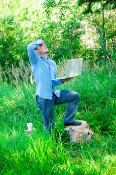 Despaired Young man outdoors with a cup and laptop