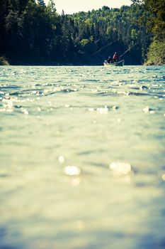 Fishermen fly fishing the salmon on a jolly-boat