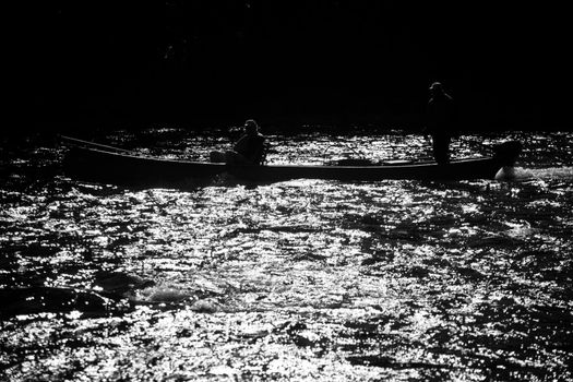 Fishermen fly fishing the salmon on a jolly-boat