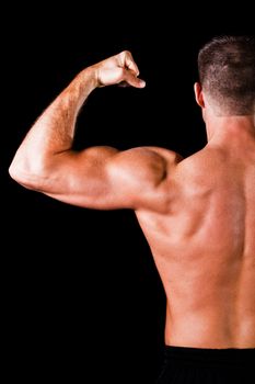 Muscular man isolated on black background