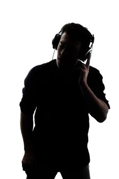 Male in silhouette listening to headphones isolated on white background