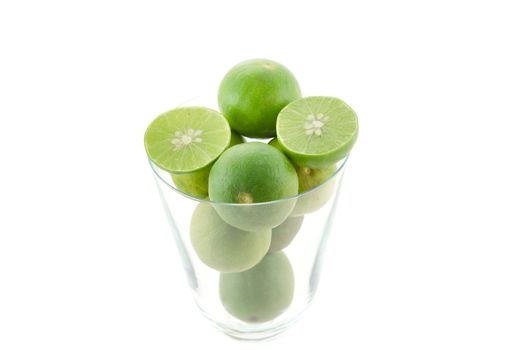 close up fresh lime and slice in glass  on white background

