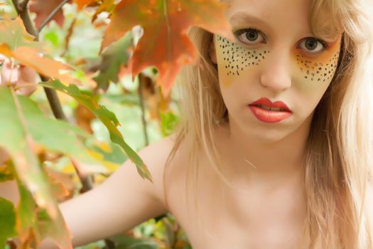 Happy teenager in a forest in the autumn