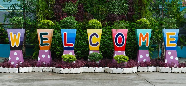 welcome sign word on colorful flower pots