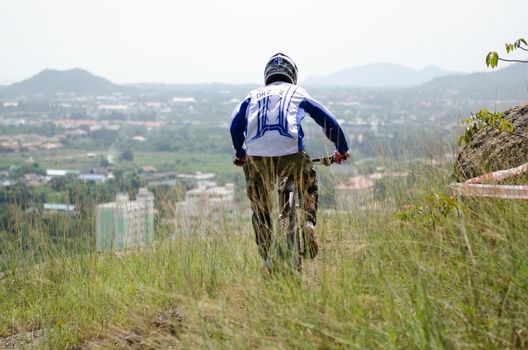 Hua Hin,Thailand - December 1st : Unidentified bicycle racing downhill competitors during the "Hua Hin mountain bike racing 2012  " at Hinlekfai mountain on December 1st, 2012 in Hua Hin,Thailand. 