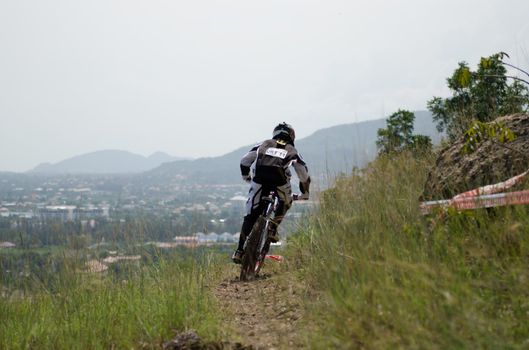 Hua Hin,Thailand - December 1st : Unidentified bicycle racing downhill competitors during the "Hua Hin mountain bike racing 2012  " at Hinlekfai mountain on December 1st, 2012 in Hua Hin,Thailand. 