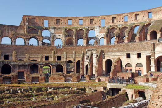 Tourists inside Colosseum ruin in Rome, Italy