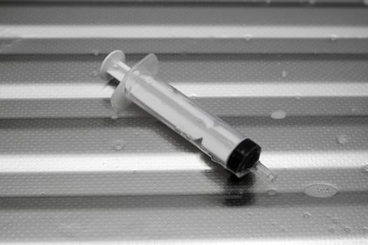 syringe on a metal surface