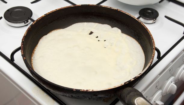 Frying a pancake cooking in a pan 