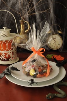 Sweets in the package on the festive table in honor of Halloween