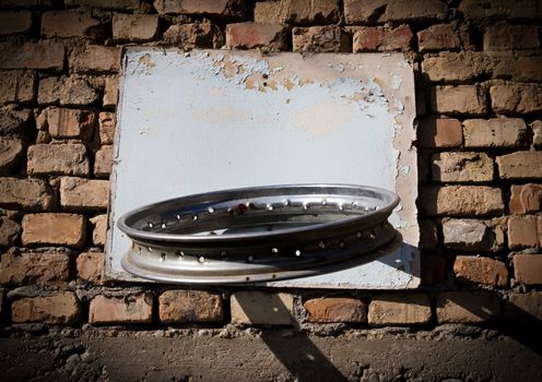 Self-made ring for basketball on a brick wall