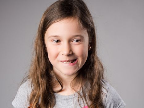 Mischievous little girl in studio