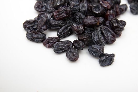 black raisins on a white background