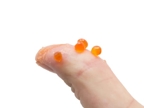 finger in red caviar on white background
