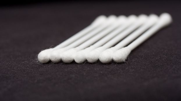 Cotton sticks isolated on black background 