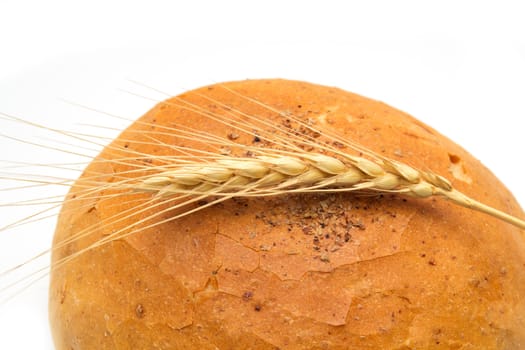 bread and wheat on a white background