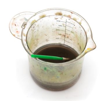 a glass of dirty water under the paint