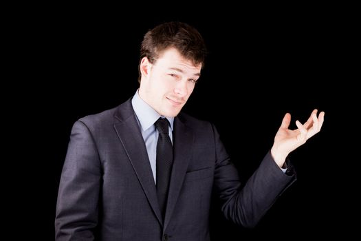 Businessman showing shomething of your choice isolated on black background