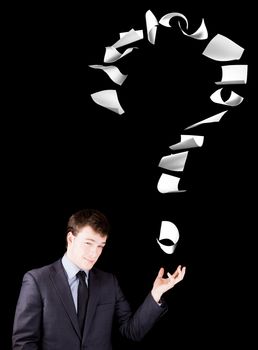 Businessman showing a question mark made of floating papers.