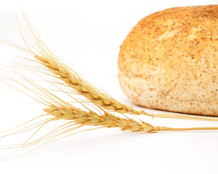 Wheat and bread on a white background