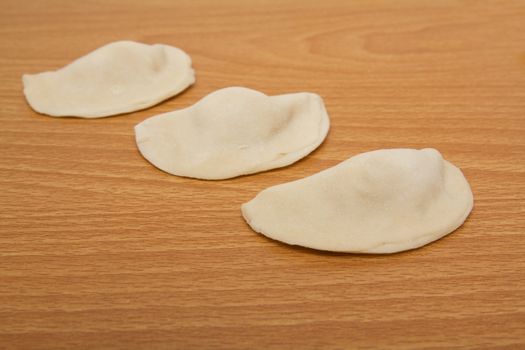 homemade meat dumplings on a cutting board 