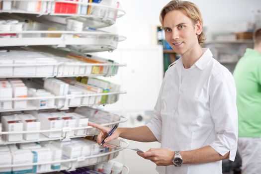 Portrait of male pharmacist working at pharmacy