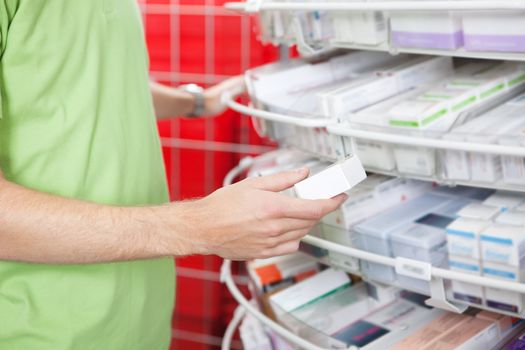 Cropped image of man holding medication box at pharmacy