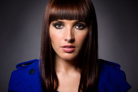 Headshot of an attractive brunette caucasian model looking directly at camera