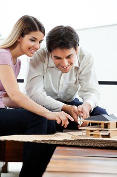 Young architects working on house model project together