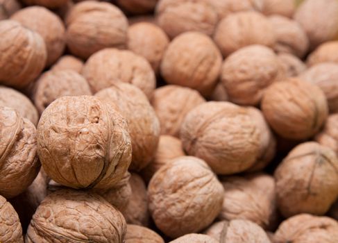 Brown raw walnuts textured background 