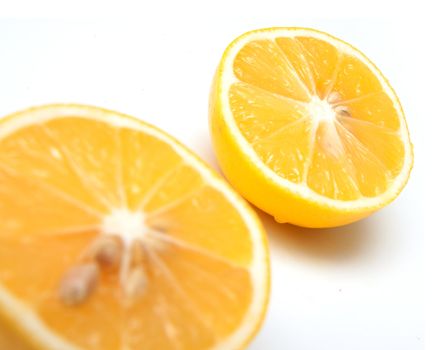 Half of a lemon with one slice isolated on white background 
