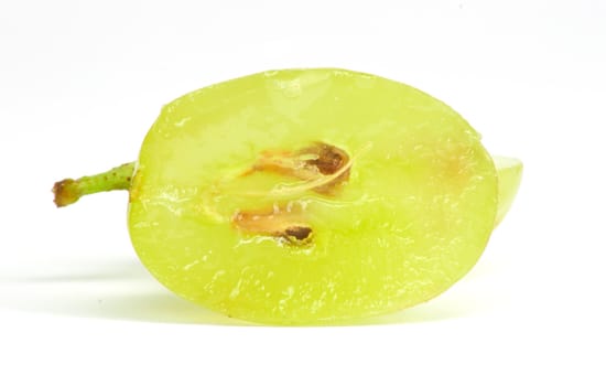 Translucent slice of green grape fruit, macro isolated on white 