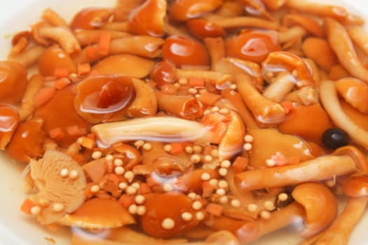 Marinated mushrooms in the background
