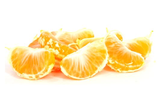 Slices of peeled orange on white background 