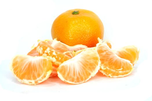 Slices of peeled orange on white background 