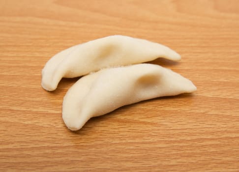 homemade meat dumplings on a cutting board 