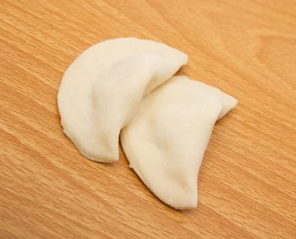homemade meat dumplings on a cutting board 