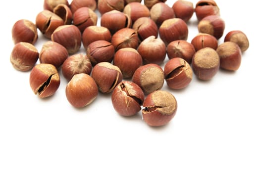 Heap of hazelnuts isolated on white background 