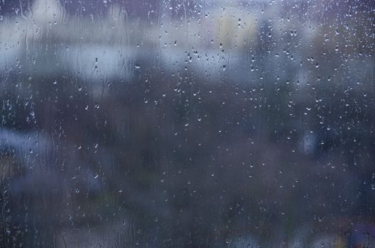 Background of water drops on a glass window with colorful background