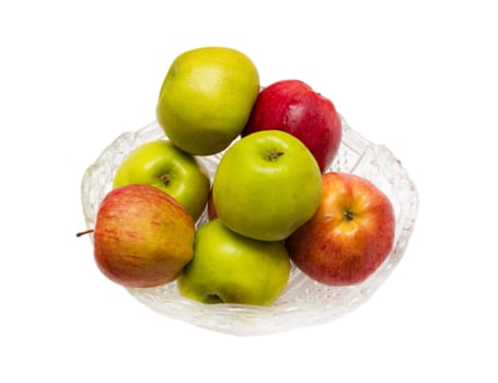 green and red apples in a crystal dish on a white background