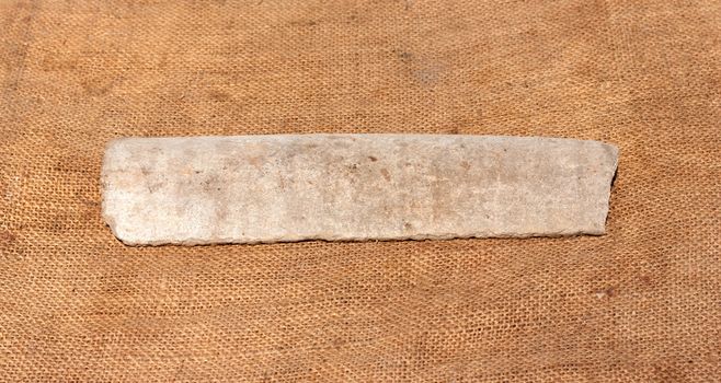 splinter asbestos pipe on fa background of the rough sackcloth