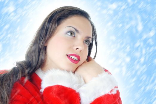 Glad dreaming woman in the red Santa Claus costume on a white and blue background with snow