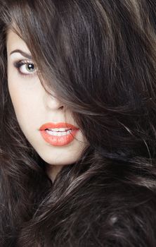 Close-up portrait of the beautiful woman with perfect makeup and hairstyle