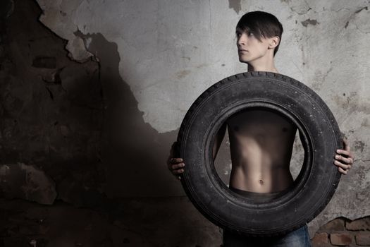 Man holding automobile tire