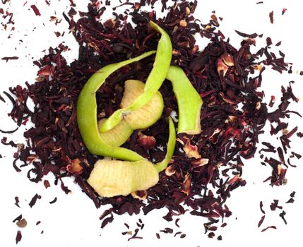 green apple peel on top of red Hibiscus tea on a white background